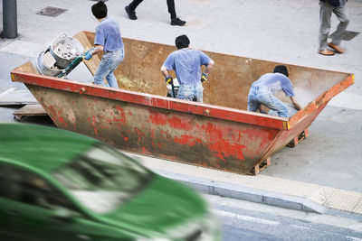 Rear view of workers working on street