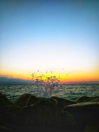 Scenic view of sea against clear sky during sunset