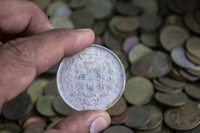 Close-up of hand holding coin