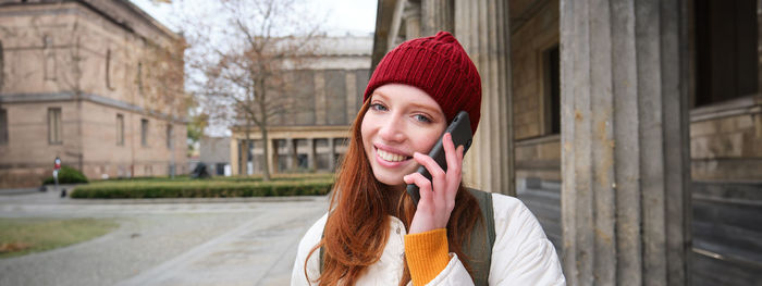 Portrait of young woman wearing warm clothing standing outdoors