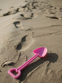 Close-up of heart shape on sand at beach