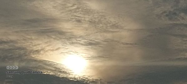 Low angle view of sign against sky during sunset