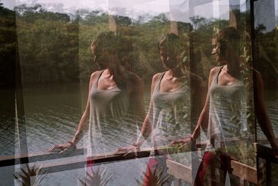 Multiple image of woman seen through glass window