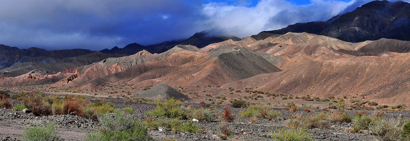 Scenic view of mountains against cloudy sky