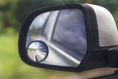 Reflection of side-view mirror of car