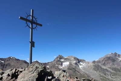 Low angle view of mountain against clear blue sky