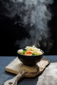 Close-up of food on table against black background