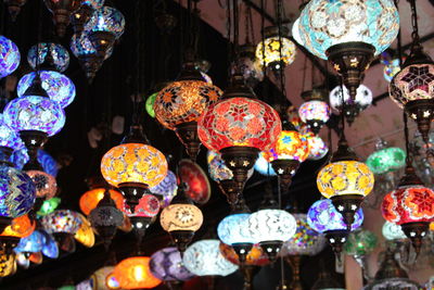 Illuminated lanterns hanging at store for sale