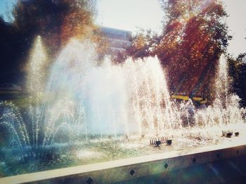 Water splashing in fountain against sky