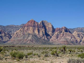 Scenic view of rocky mountains against clear blue sky