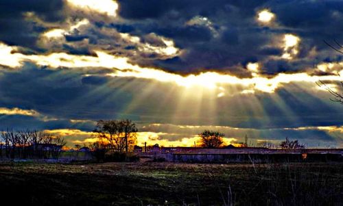 Scenic view of field against sky at sunset