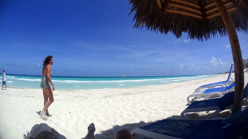 Rear view of man standing on beach