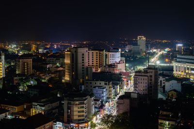 High angle view of illuminated buildings in city at night