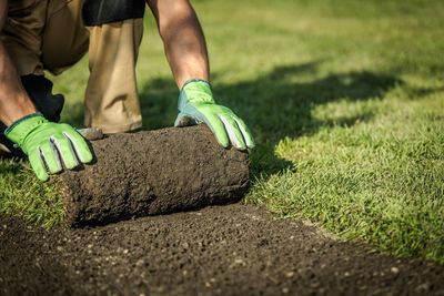 Low section of man working on field