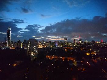 Illuminated cityscape against sky at night