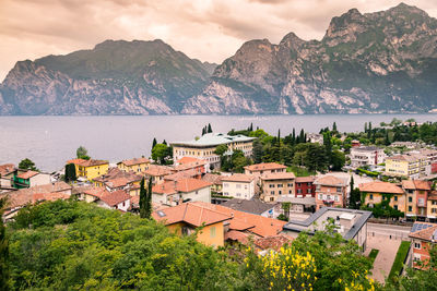 High angle view of townscape by mountain against sky