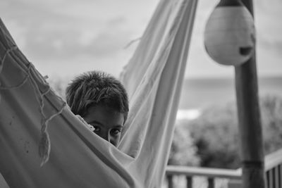 Portrait of boy in park against sky