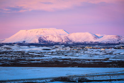 Scenic view of frozen lake against sky during sunset