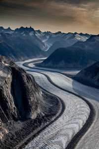 Scenic view of snowcapped mountains against sky during sunset