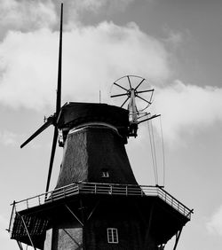 Low angle view of traditional windmill against sky