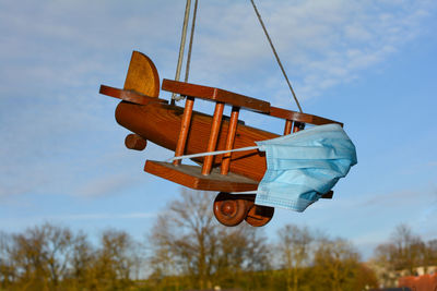 Low angle view of helicopter against blue sky