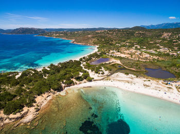 High angle view of swimming pool by sea against blue sky