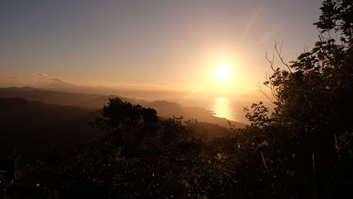 Scenic view of silhouette mountains against sky at sunset