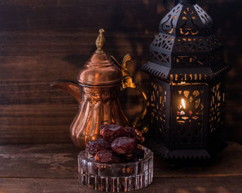 Close-up of illuminated lantern on table