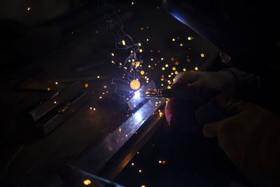 Metal welding. blue light. sparks from heating of steel. welder works in workshop. 