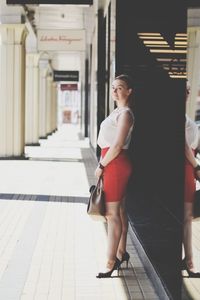 Woman standing in corridor of building