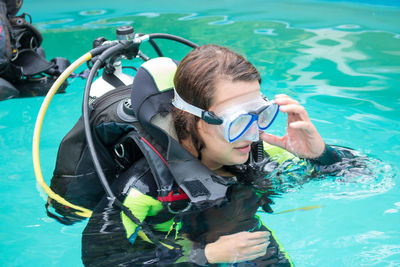 High angle view of woman with aqualung swimming in pool