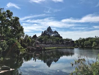 Scenic view of lake by building against sky