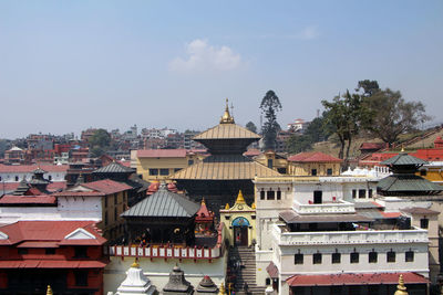 Pashupatinath temple amidst buildings against sky