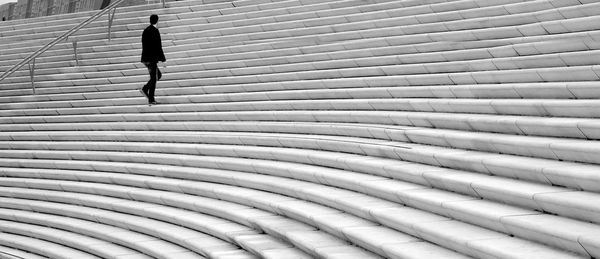 Full length of man walking on zebra crossing