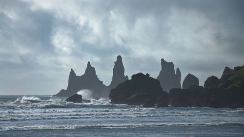 Scenic view of sea against cloudy sky