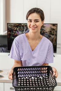 Portrait of smiling woman using calculator