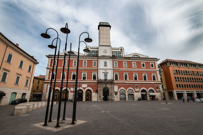 Low angle view of building against cloudy sky