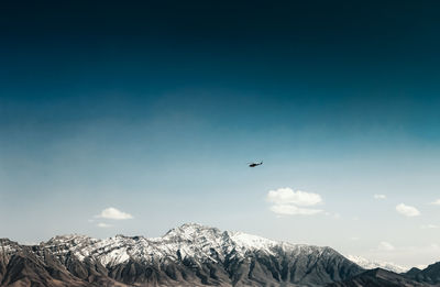 Scenic view of mountains against blue sky