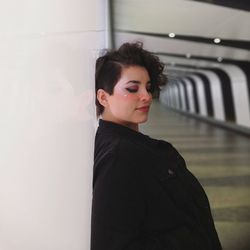 Thoughtful young woman standing in underground walkway