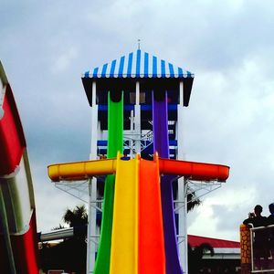 Low angle view of multi colored umbrellas against sky