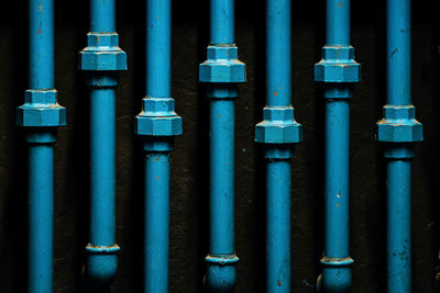 Close-up of blue pipelines at night