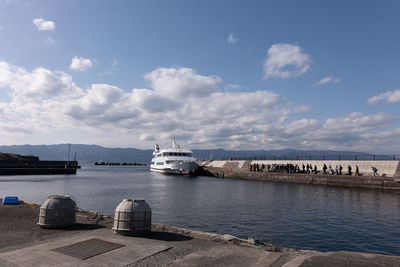 Ferry docked at the harbor under blue sky