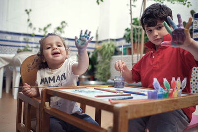 Happy friends sitting on table