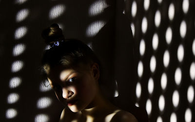 Close-up portrait of young woman looking away