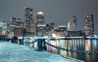 Illuminated cityscape against sky at night