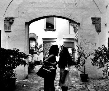 Young woman standing against wall