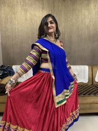 Portrait of woman wearing sari standing at home