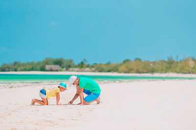 People on beach against sky