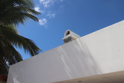 Low angle view of white building against blue sky