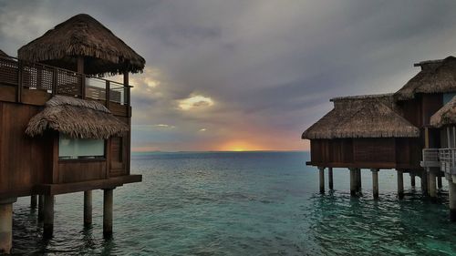 Pier on sea at sunset